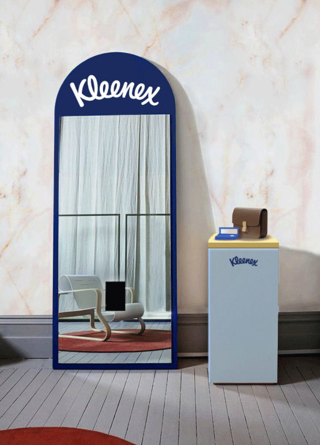 A Kleenex mirror display with the compact tissue box on a plinth