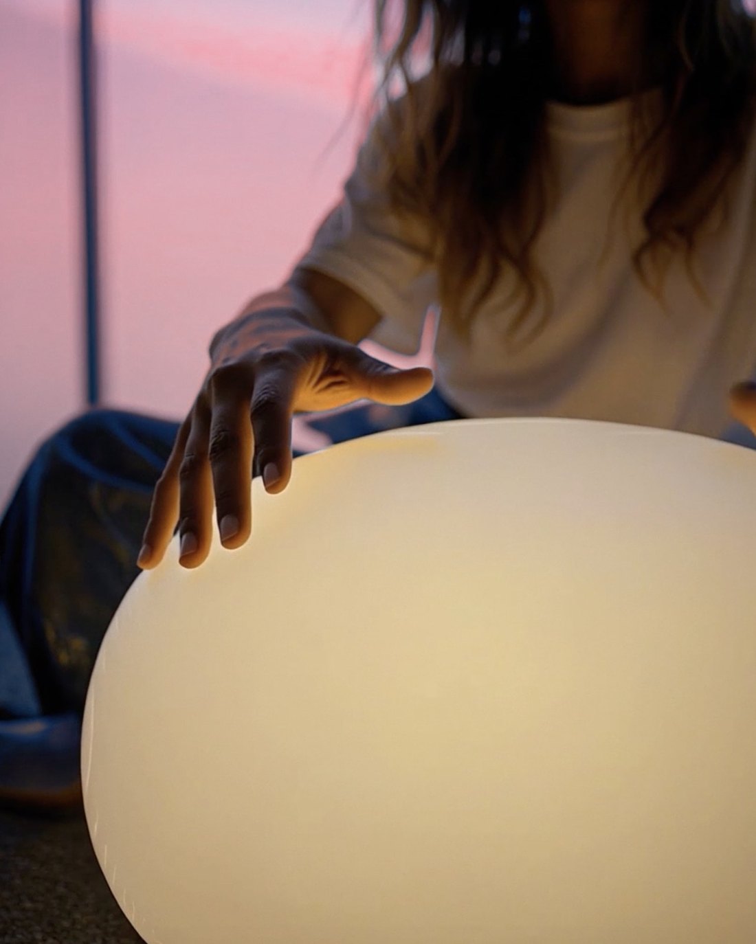A hand resting on a glowing orb