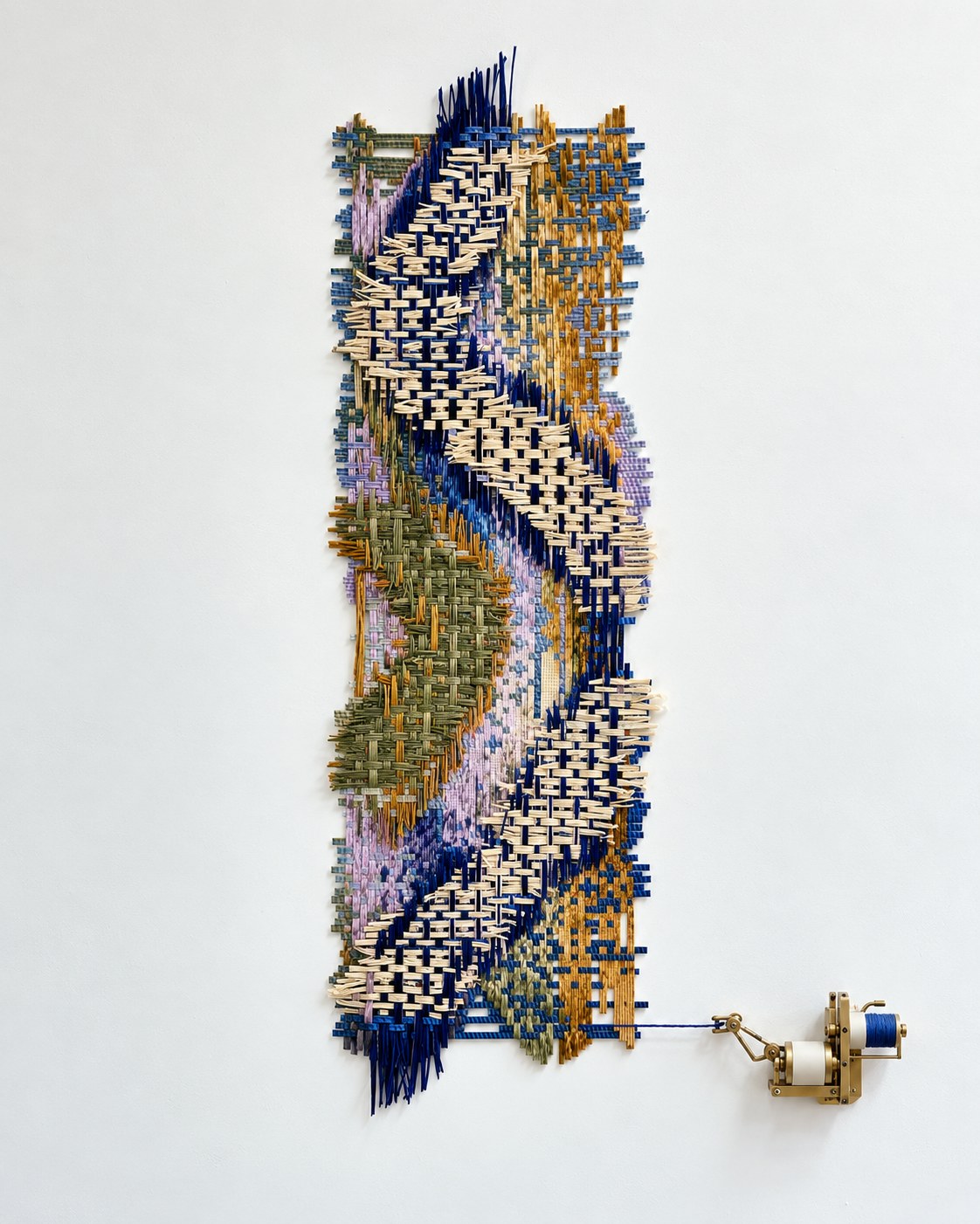 A woven calendar on the wall, with a brass mechanism unpicking one thread
